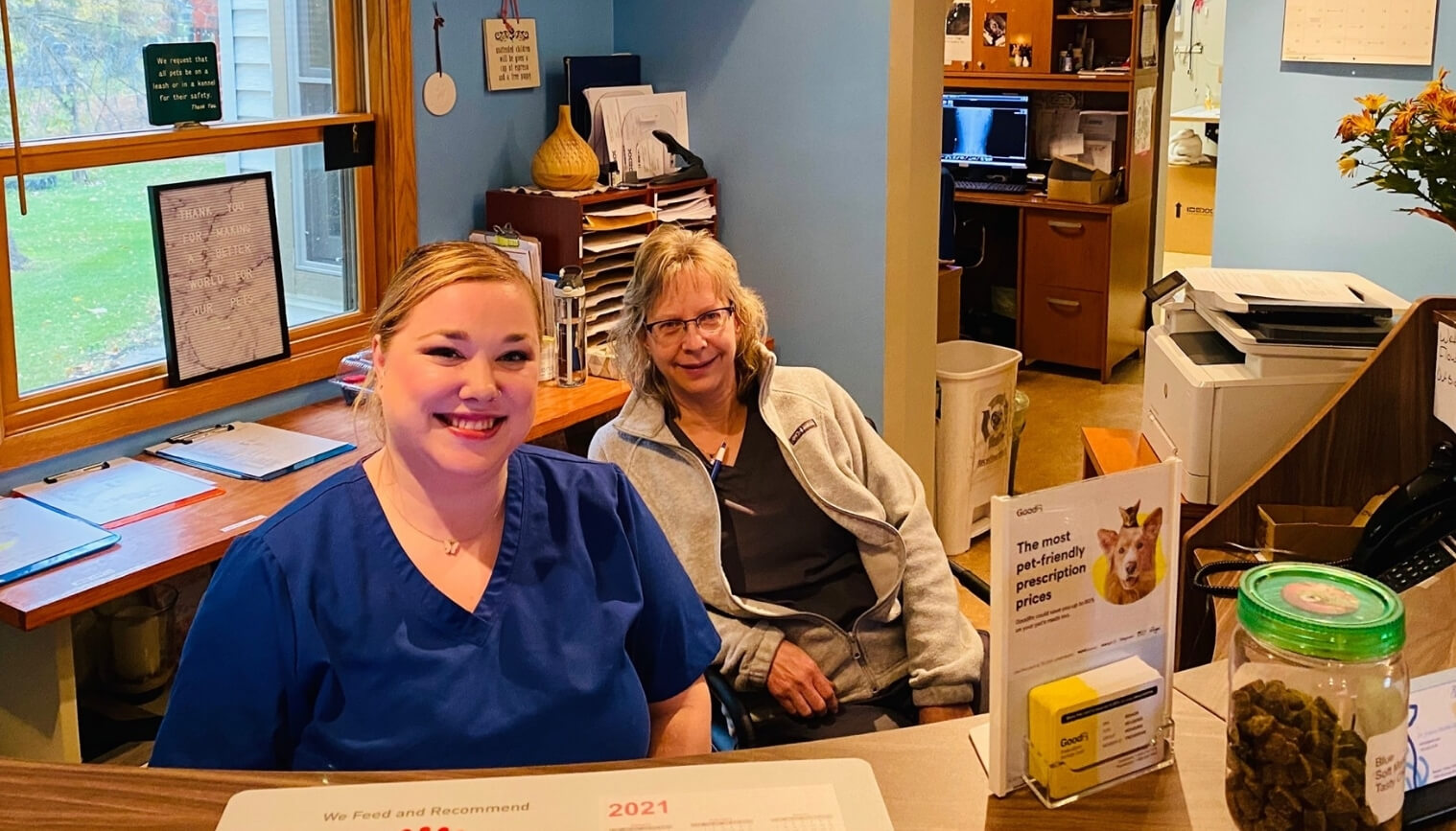 Two staff members at the reception desk